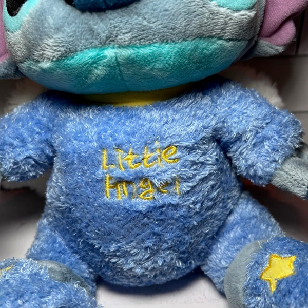 Blue plush toy with 'Little Angel' embroidered on it, held by a person.