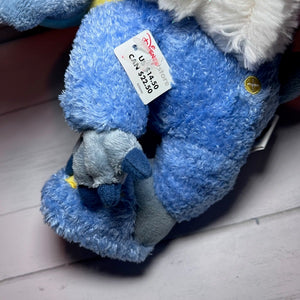 Blue plush toy with a tag on a light wooden floor