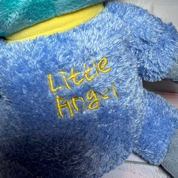 Blue plush toy with 'Little Angel' embroidered on it