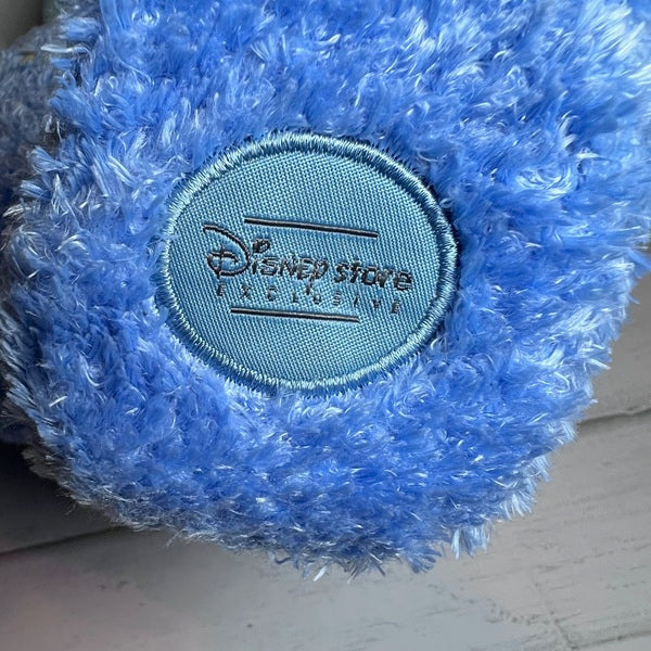 Blue plush toy with a Disney Store tag on a light background