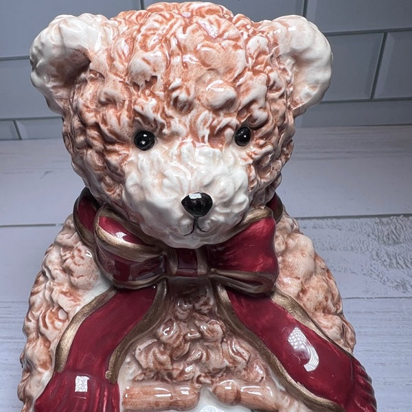 Decorative teddy bear with a red bow tie on a white background