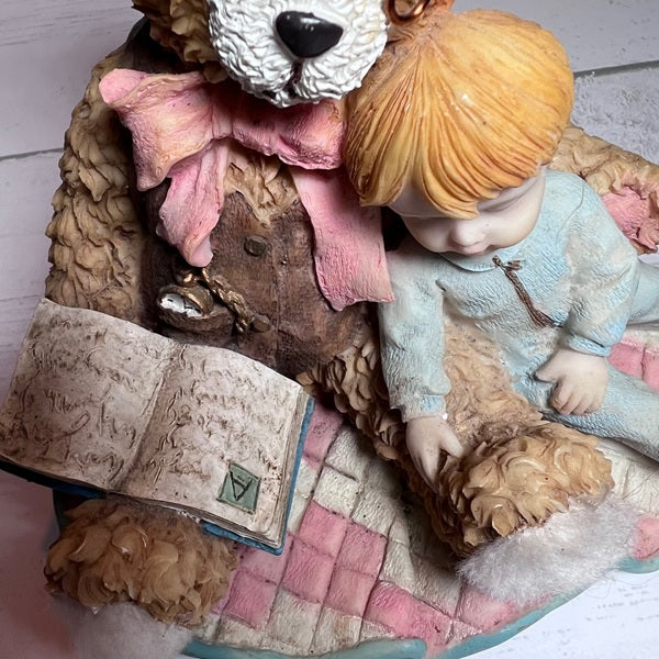 Teddy bear and child with an open book on a checkered surface
