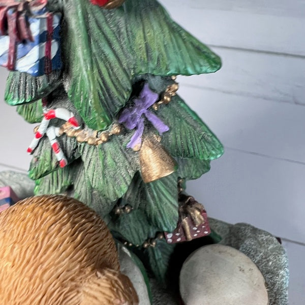 Decorative Christmas tree figurine with ornaments on a white background