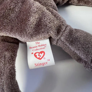 Close-up of a plush toy with a Ty Beanie Babies tag on a white background