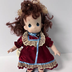 Doll with red dress and lace details on a white background