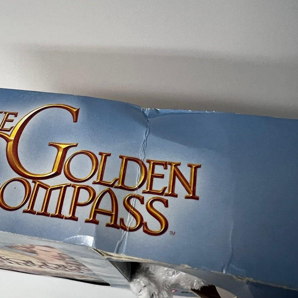 Close-up of 'The Golden Compass' logo on a blue background