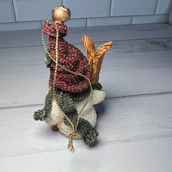 Decorative figurine with a textured surface on a light wooden floor.