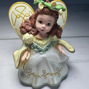 Decorative angel figurine with gold wings on a white background