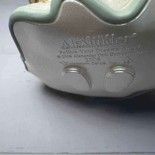Close-up of a toy with 'Alexander' branding on a light gray background