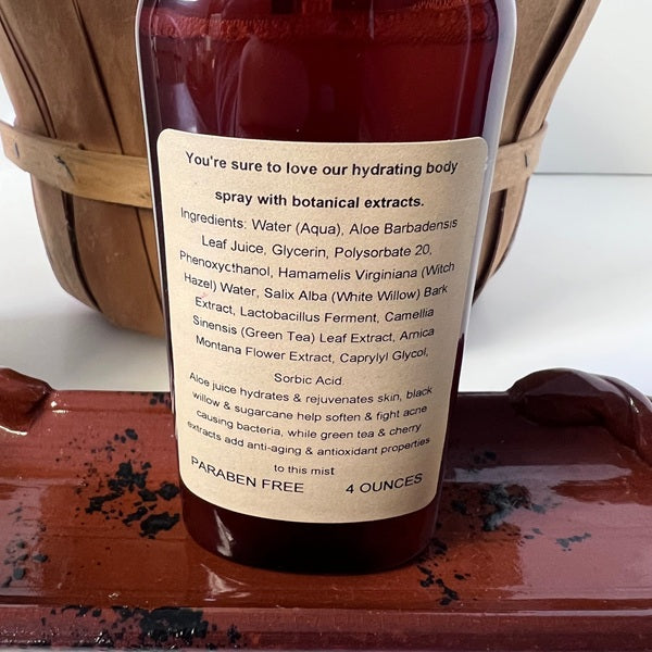 Bottle of hydrating body spray with botanical extracts on a wooden surface