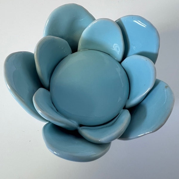 Blue ceramic succulent-shaped candle holder on a white background
