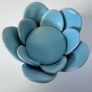 Blue ceramic succulent-shaped candle holder on a white background