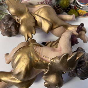 Decorative figurine with gold and brown elements on a white background