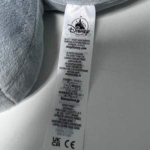 Gray plush toy with a Disney tag on a light gray background