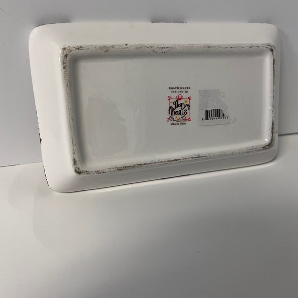 Rectangular white ceramic tray with a brand label on a gray background