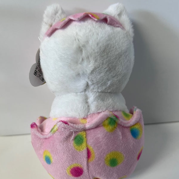 White plush toy with a pink polka dot outfit on a white background