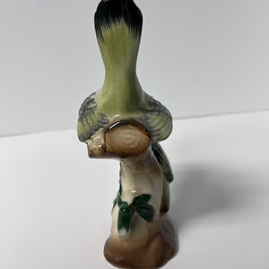 Ceramic bird figurine on a white background