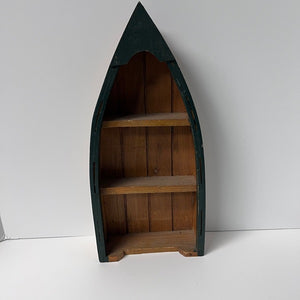 Wooden boat-shaped shelf with green rim on a white background