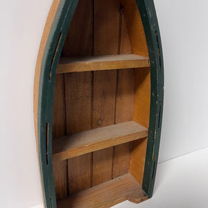 Wooden shelf shaped like a boat on a white background