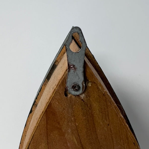 Wooden frame corner with metal clip on a white background