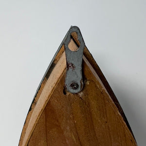 Wooden frame corner with metal clip on a white background