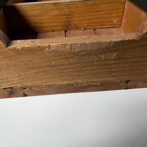 Close-up of a wooden surface with visible grain and texture.