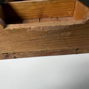 Close-up of a wooden surface with visible grain and texture.