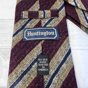 Striped tie with 'Huntington' label on a white background