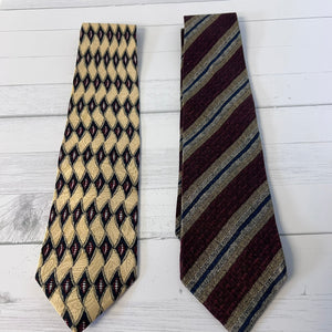 Two patterned ties on a white wooden surface