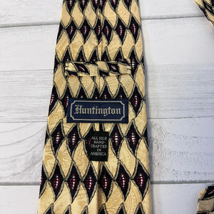 Patterned tie with 'Huntington' label on a light wooden surface