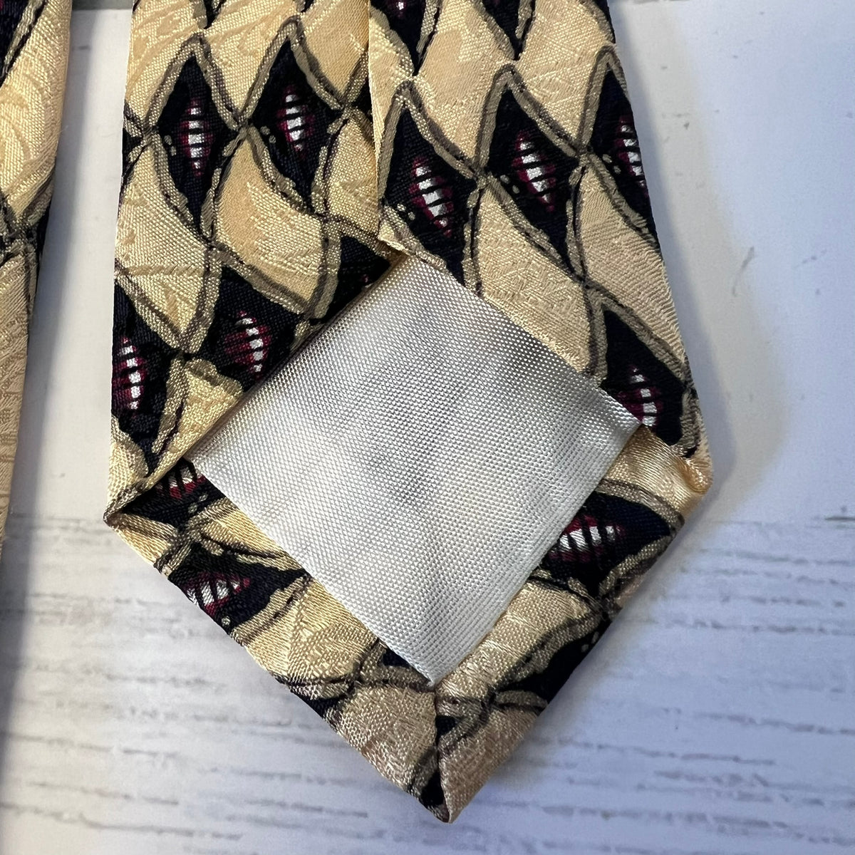 Patterned tie and pocket square on a textured surface