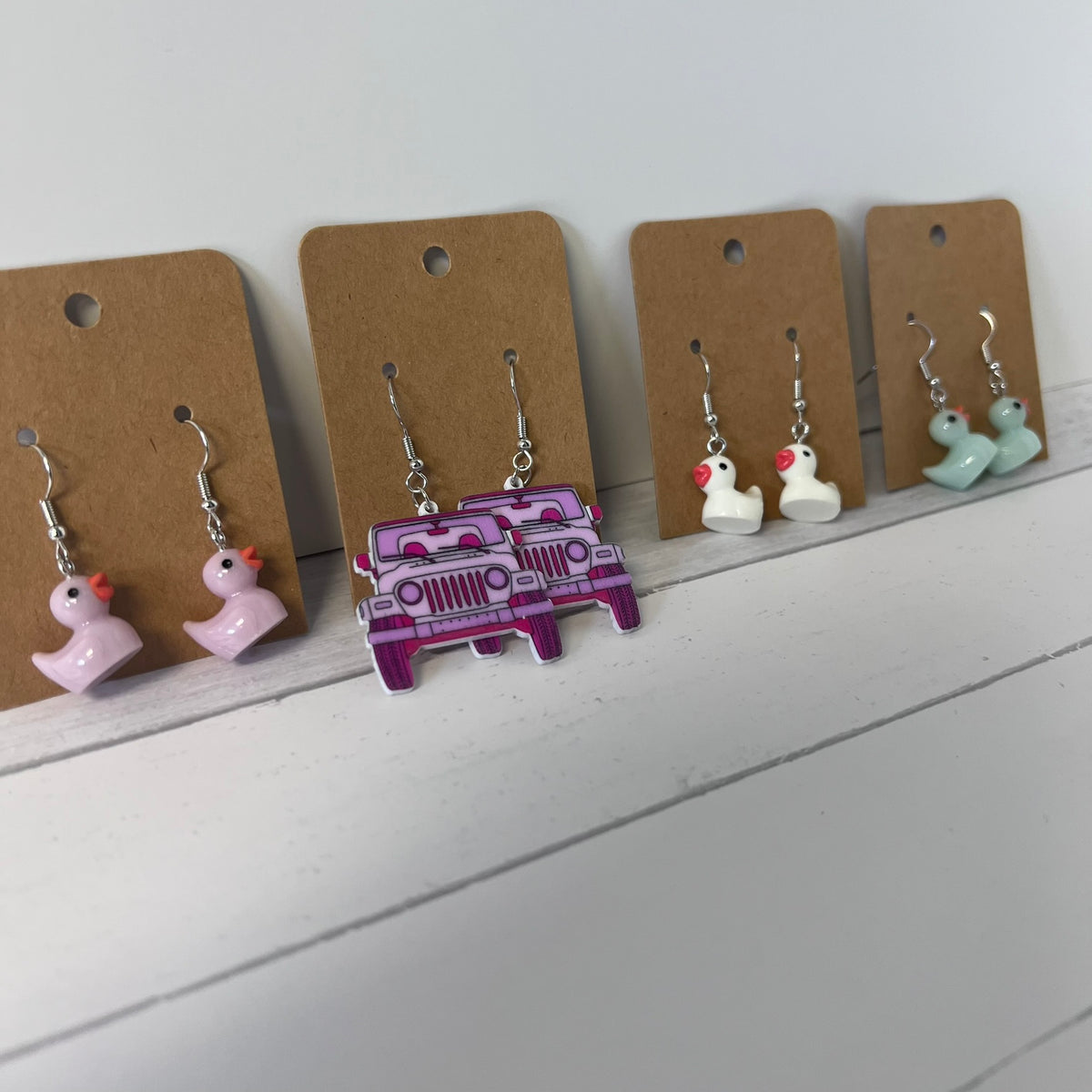 Set of earrings on brown card with a white background