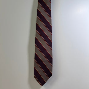 Striped tie on a light gray background
