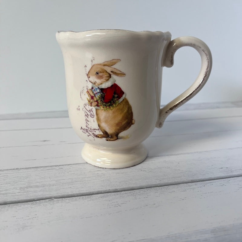 Ceramic mug with a rabbit design on a wooden surface