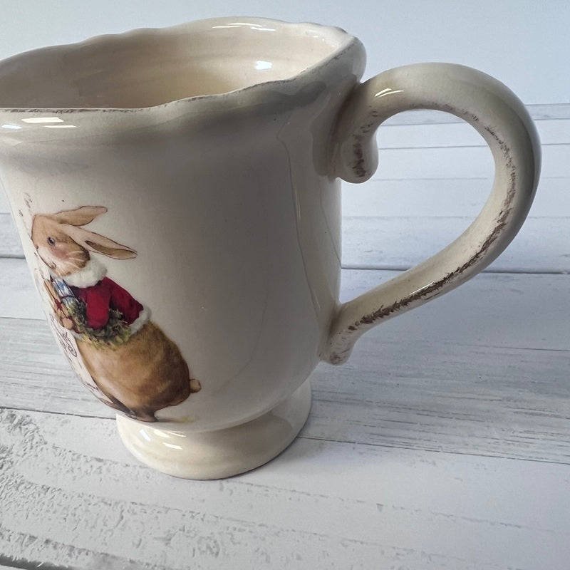 Ceramic mug with a rabbit illustration on a wooden surface