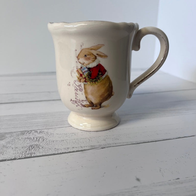 White ceramic mug with a rabbit illustration on a wooden surface