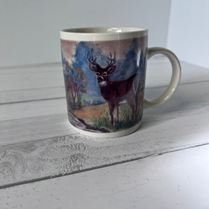 Mug with a deer design on a wooden surface