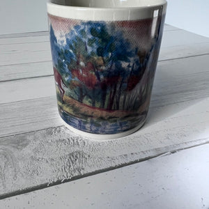Mug with a scenic design on a wooden surface
