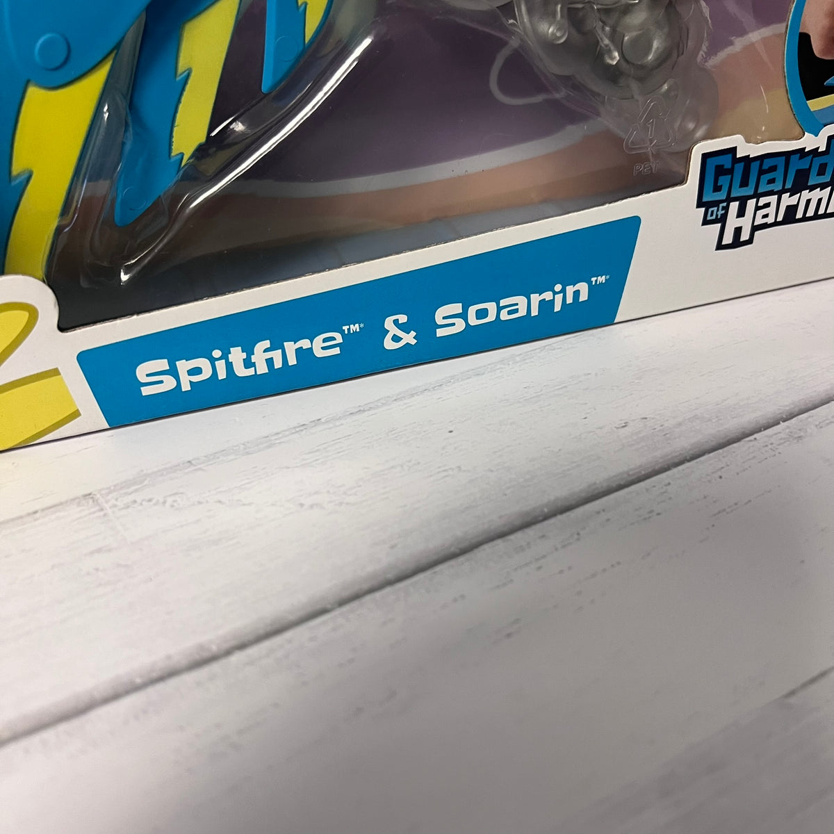 Toy packaging with 'Spitfire & Soarin'' branding on a wooden surface