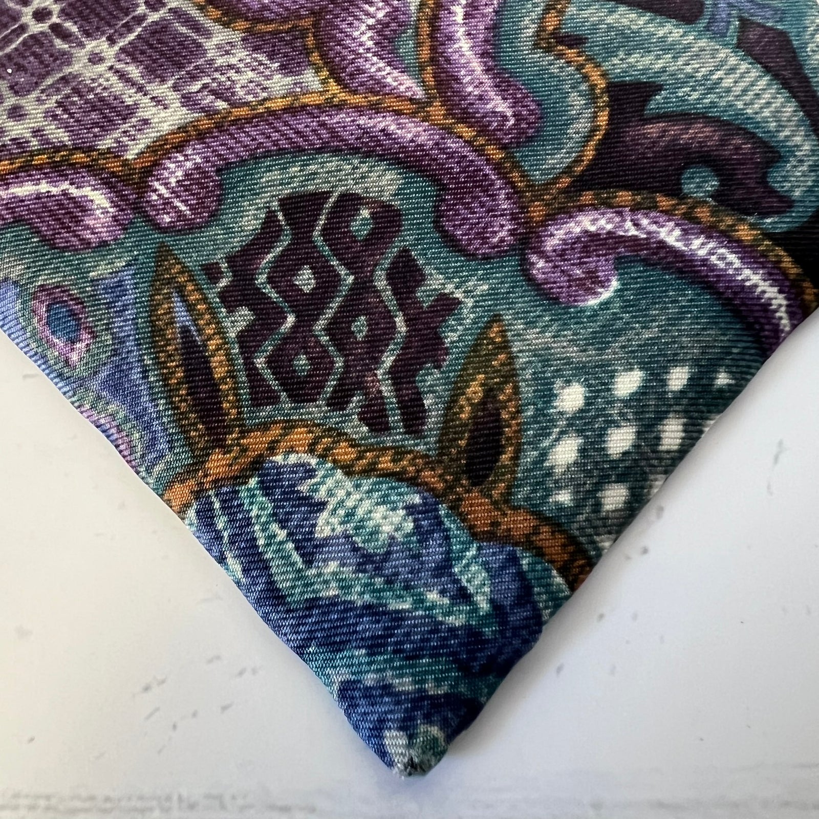 Close-up of a patterned fabric with intricate designs on a white background