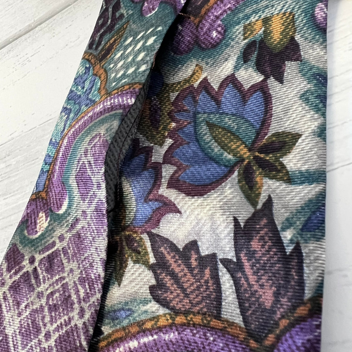 Close-up of a patterned fabric with floral design on a white background