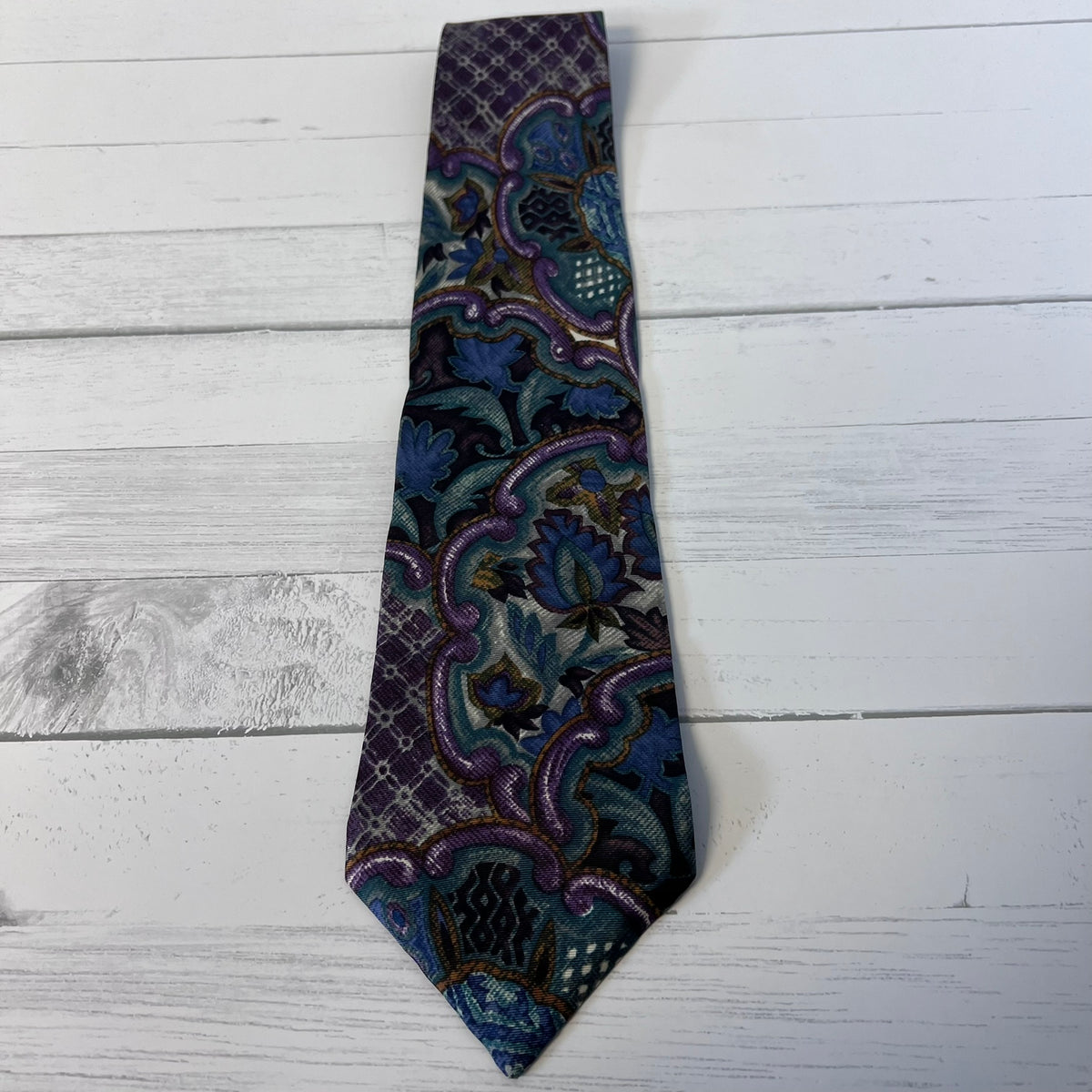 Patterned tie on a light wooden surface
