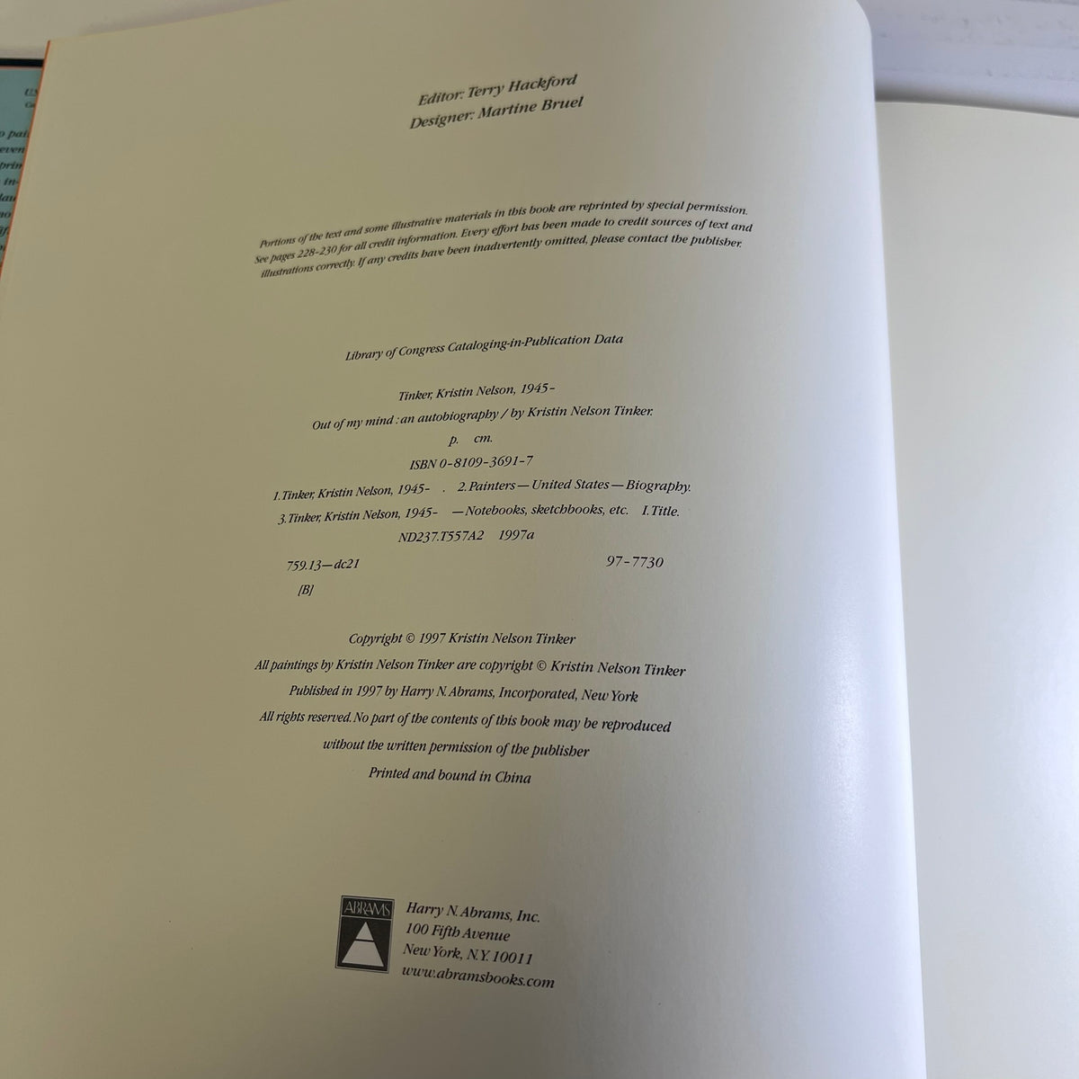 A photographed interior page from a printed book or publication, showing publication credits, copyright text, and publisher information on an off-white page.