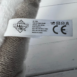 Label on a plush toy with branding and product information.
