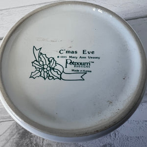 Ceramic plate with 'Christmas Eve' design and branding on a light wooden surface