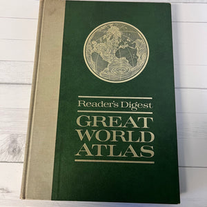 Reader's Digest Great World Atlas on a wooden surface
