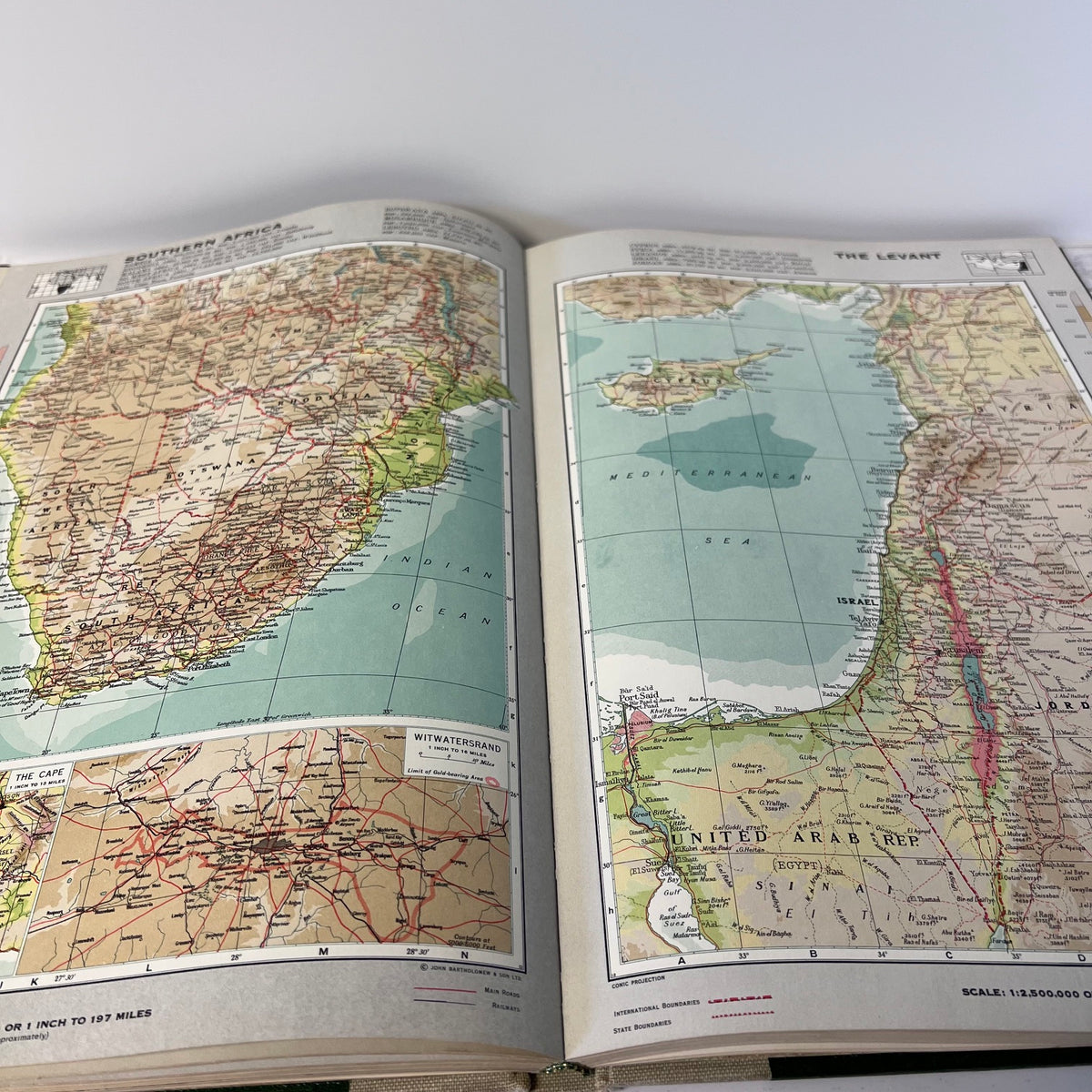Open book displaying maps of different regions