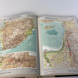 Open book displaying maps of different regions