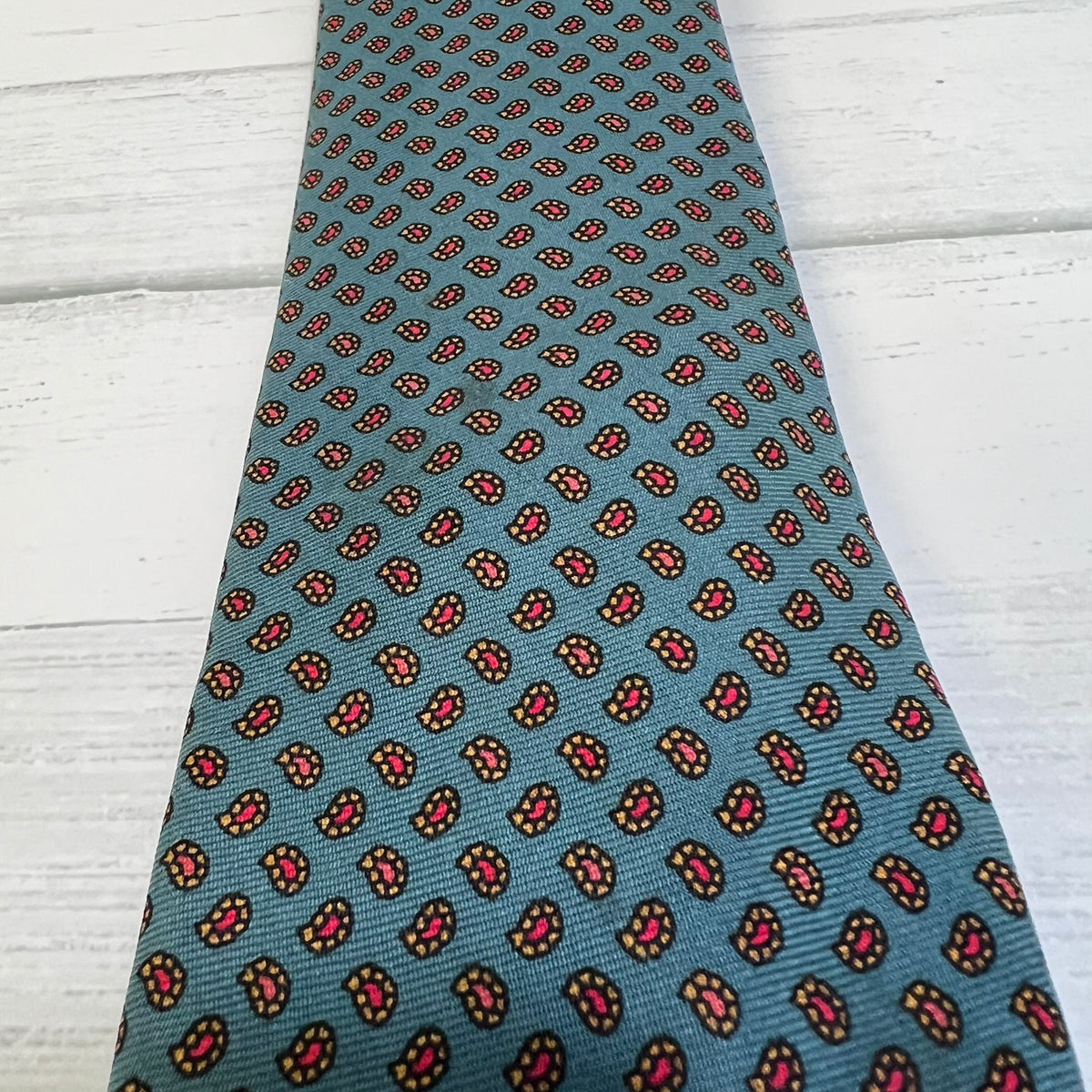 Patterned tie on a light wooden surface