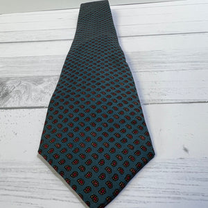 Black patterned tie on a light wooden surface